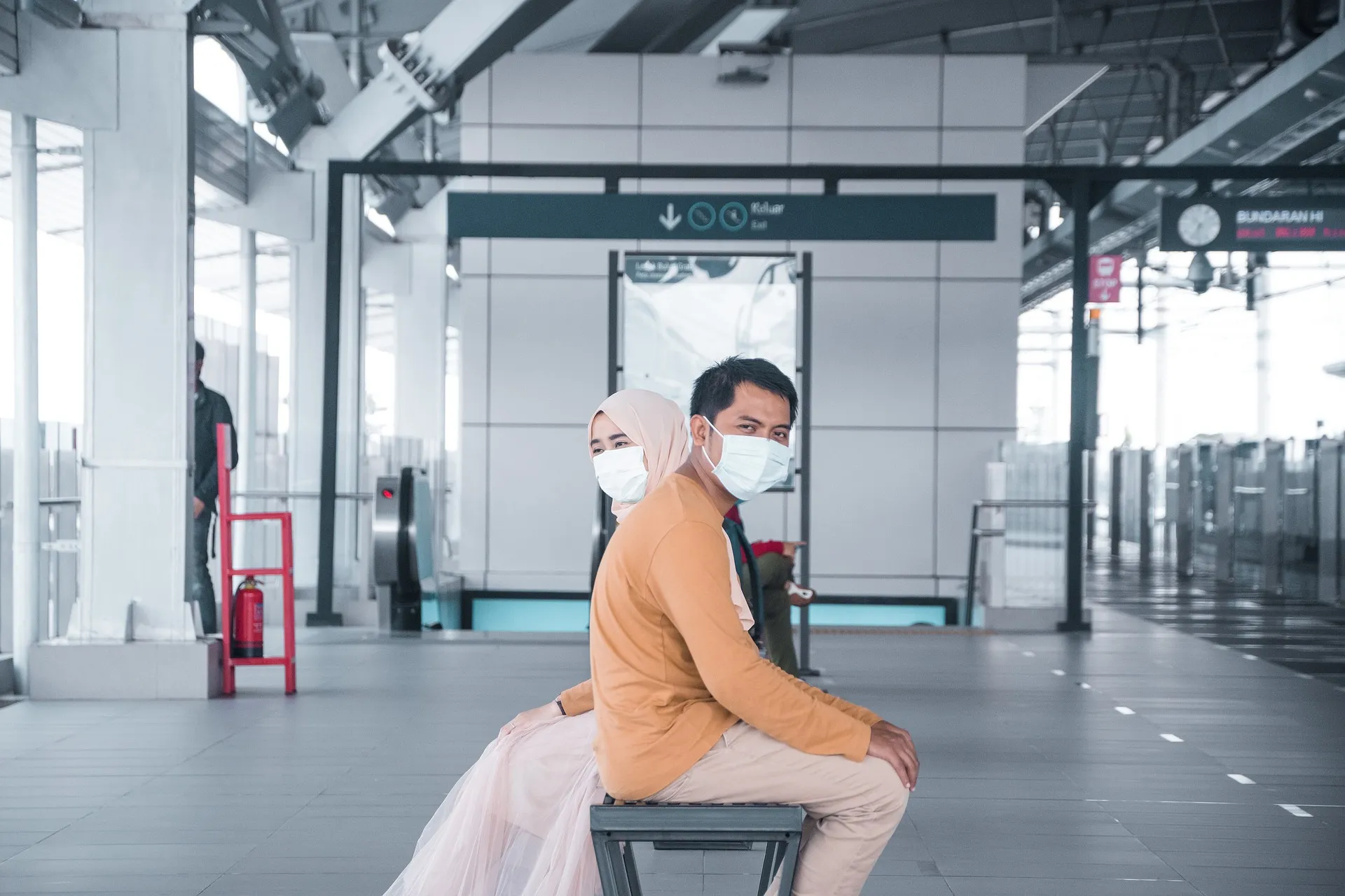 Couple at Train Station Social Distancing