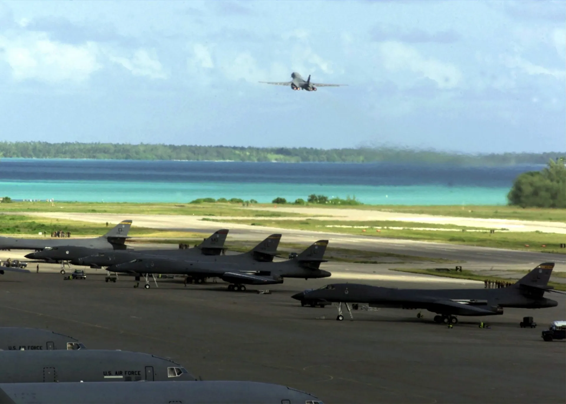 A US Air Force B-1B Lancer taking off from Diego Garcia as part of Operation Enduring Freedom during October 2001. Five other B-1Bs are visible parked in the foreground.
