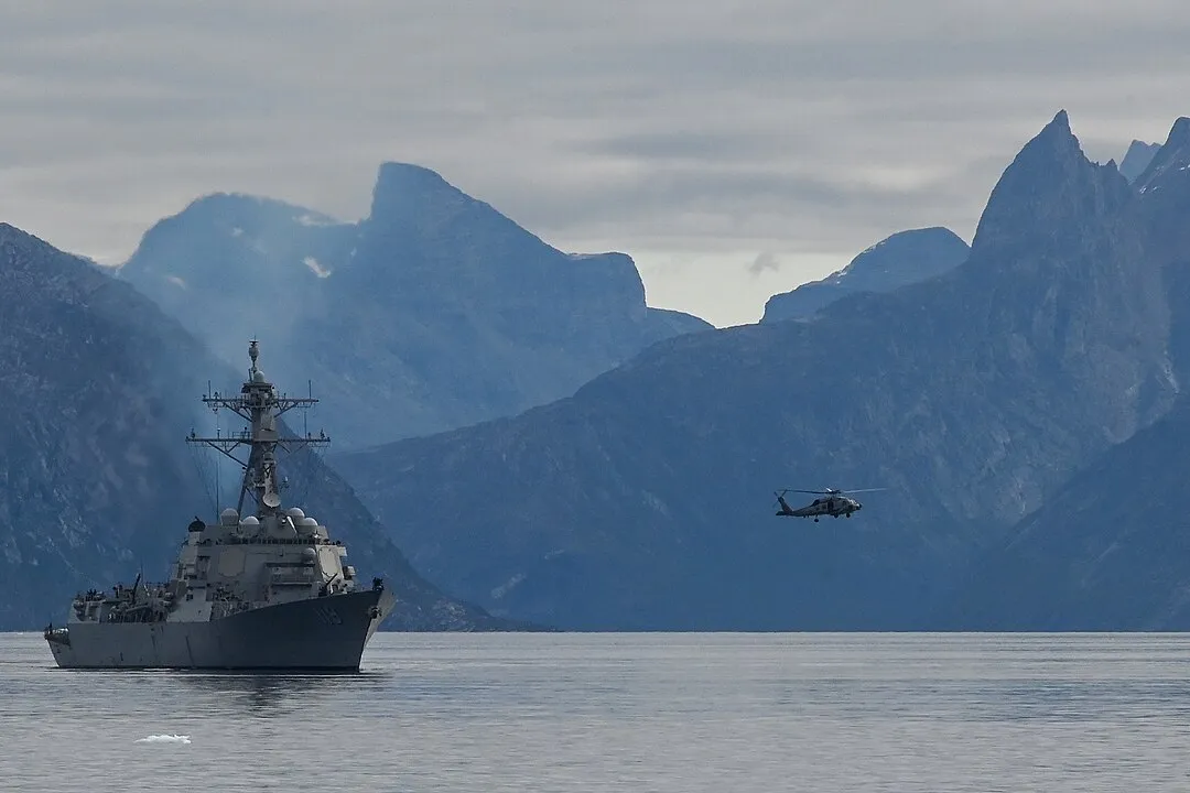 From official image description: Arleigh Burke-class guided-missile destroyer USS Delbert D. Black (DDG 119) and an embarked U.S. Navy MH-60R Seahawk helicopter aircrew transit through the Nuup Kagerlua Fjord, Aug. 21, 2024, near Nuuk, Greenland. The Delbert D. Black partnered with the U.S. Coast Guard, Royal Canadian and Royal Danish navies during Operation Nanook. (U.S. Coast Guard photo by Petty Officer 3rd Class Anthony Randisi)