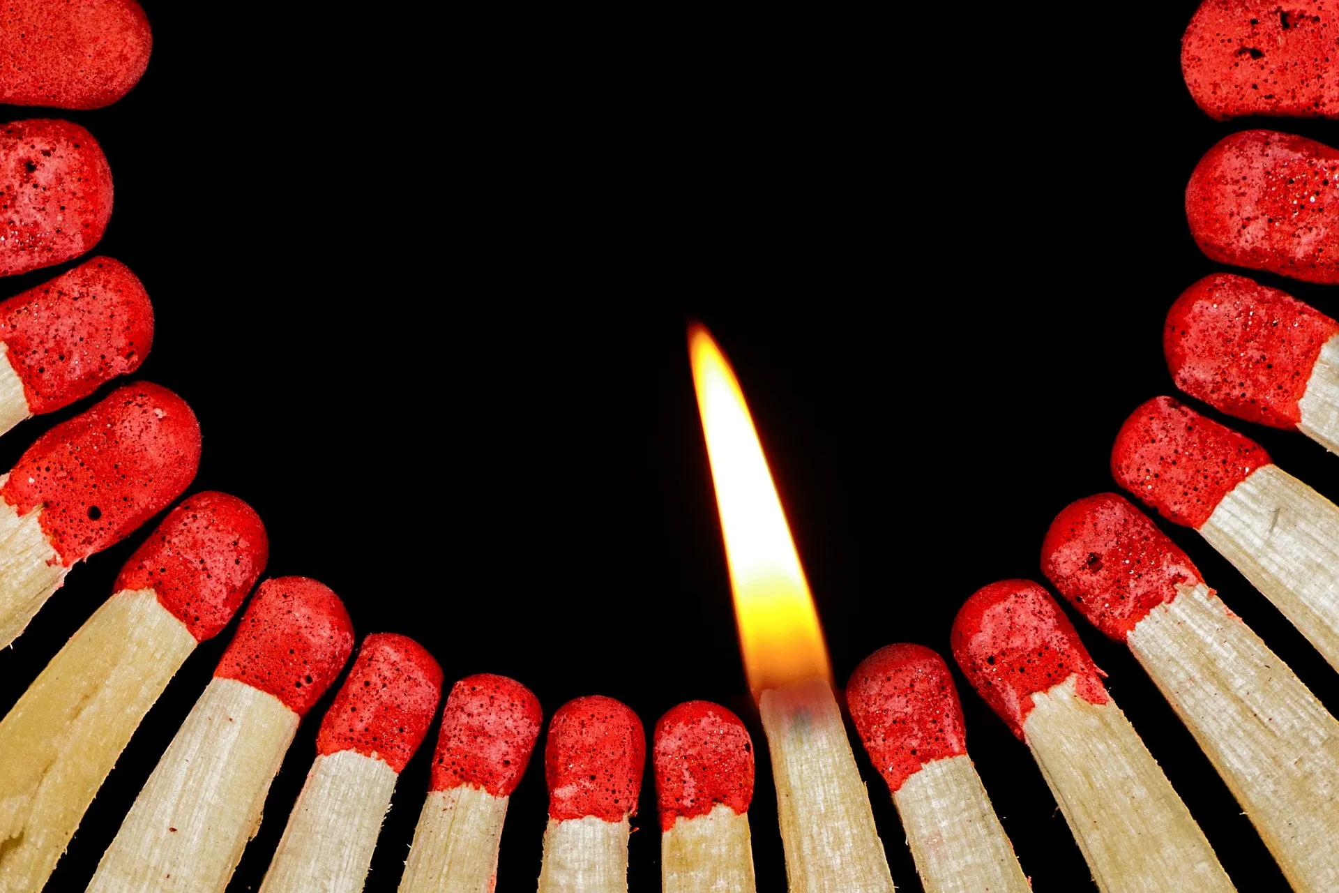 Lit Match next to a circle of matches about to go up