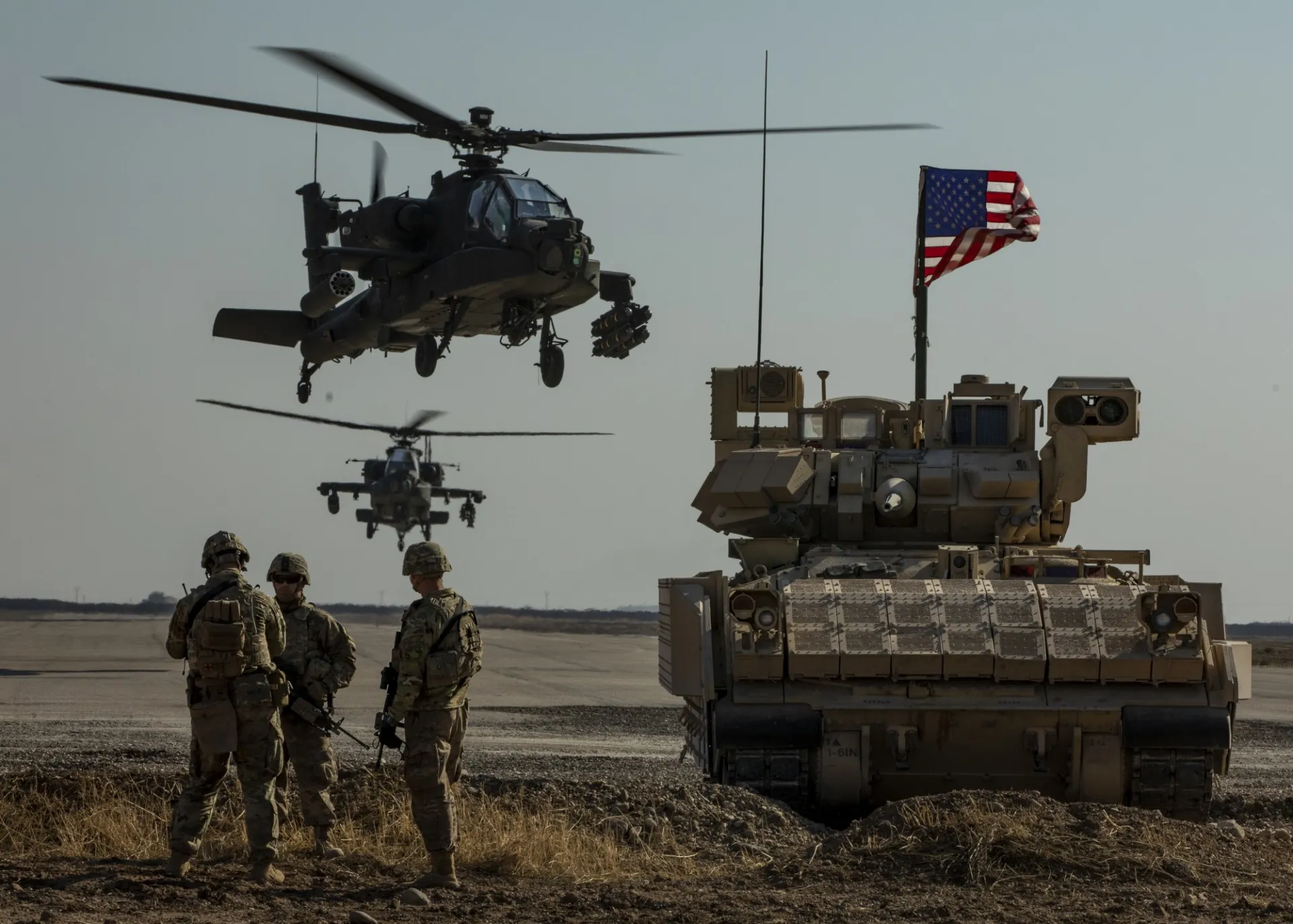 1st Armored Division infantry, an M2 Bradley armored vehicle, and AH-64 Apache attack helicopters as part of Combined Joint Task Force – Operation Inherent Resolve in Syria

