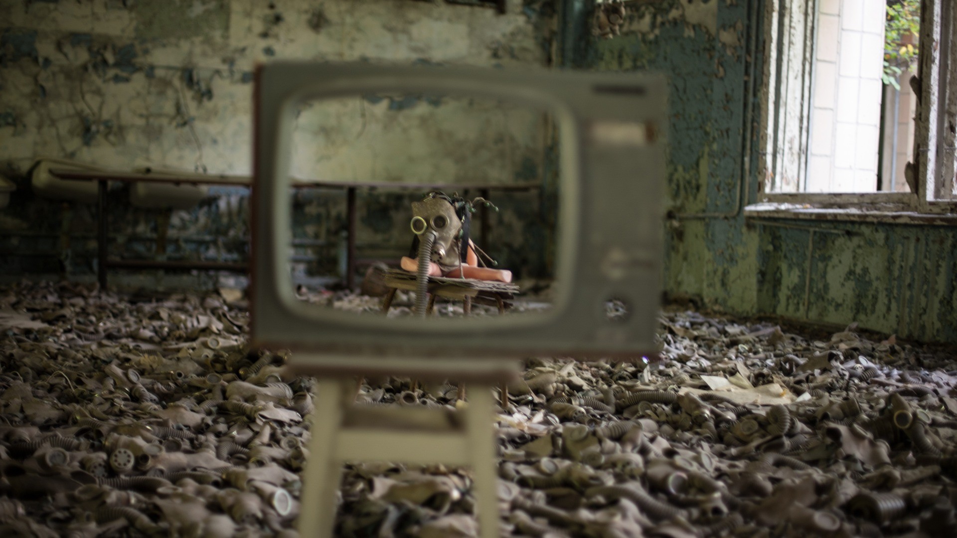 Cold War wreckage masks on floor and burnt TV